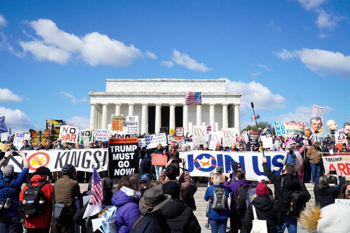 Protesters stand on the steps of the Lincoln Memorial holding flags and signs. Saturday, March 28, 2026. Washington D.C. (Staff Writer / Nick DiCicco) 