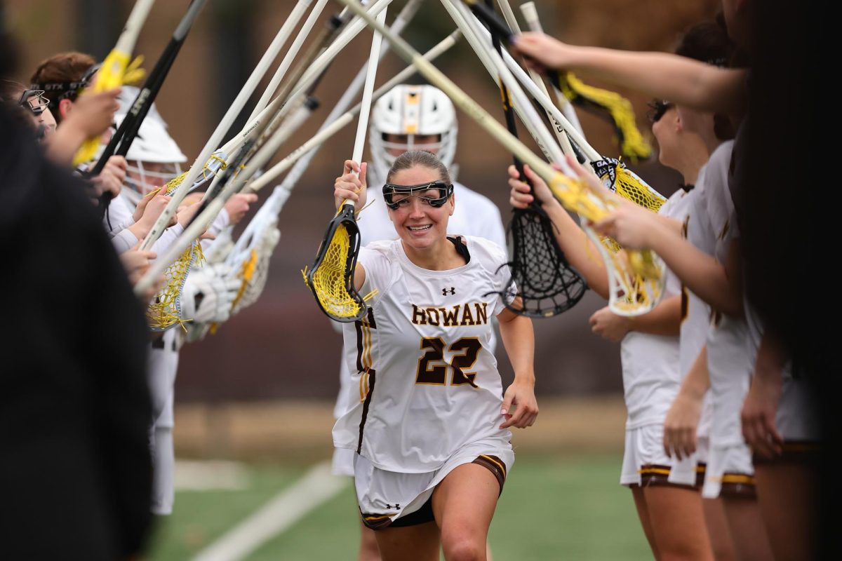 Jenna O’Neill runs through the players’ tunnel ahead of Rowan Women's Lacrosse facing Ursinus. Glassboro, N.J. March 4, 2026. (Chris Taylor / Rowan Athletics)