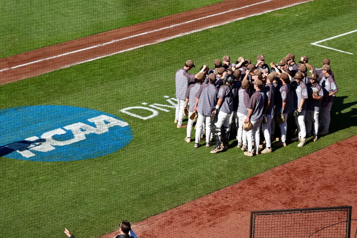 The Profs huddle up before their first game of the 2026 NCAA Division III Baseball Championship. Eastlake, Ohio. Friday, May 29, 2026. (Stockton Photo, Inc.)