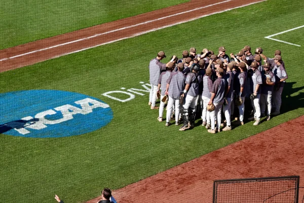 The Profs huddle up before their first game of the 2026 NCAA Division III Baseball Championship. Eastlake, Ohio. Friday, May 29, 2026. (Stockton Photo, Inc.)